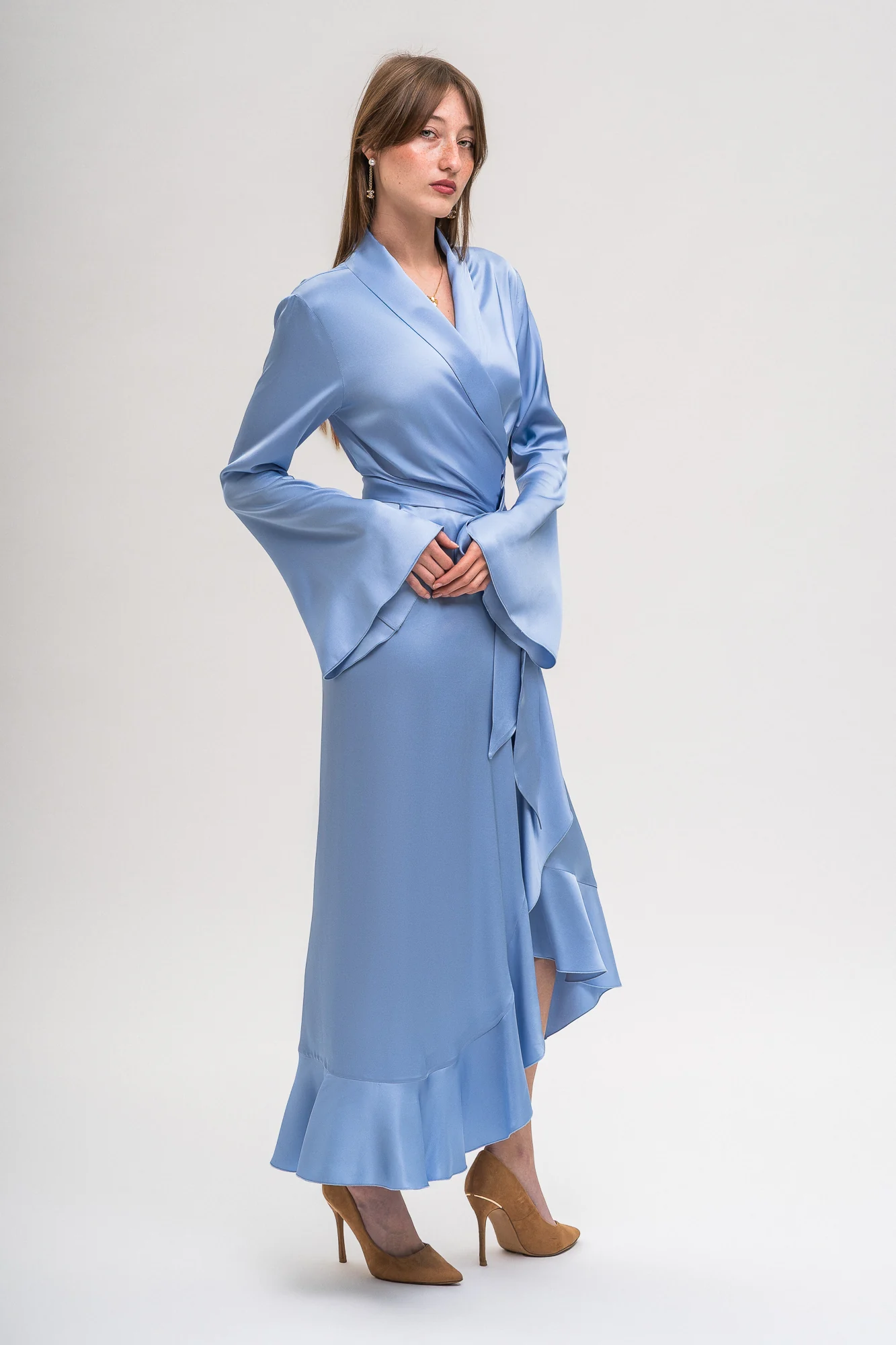 Incantevole Milano Fall Winter 2026–2027 – pale blue wrap dress with flared cuffs and an asymmetric ruffled hem