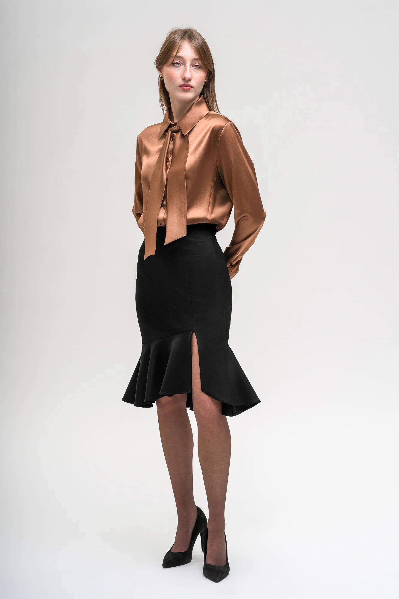 Incantevole Milano Fall Winter 2026–2027 – bronze tie-neck blouse and black ruffled skirt